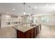 Open kitchen with large island and built-in shelving at 5575 W Cinder Brook Way, Florence, AZ 85132