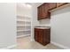 Laundry room with washer, dryer, cabinets, and shelving at 5575 W Cinder Brook Way, Florence, AZ 85132