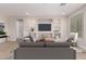 Bright living room features built-in shelving and a cozy seating area at 5575 W Cinder Brook Way, Florence, AZ 85132