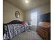 Cozy bedroom with a double bed, dresser, and window coverings at 650 N Hawes Rd # 2713, Mesa, AZ 85207