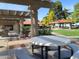 Relaxing community patio with pergola, tables, and grills at 650 N Hawes Rd # 2713, Mesa, AZ 85207