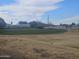 Golf course with green putting area and distant buildings at 650 N Hawes Rd # 2713, Mesa, AZ 85207