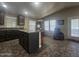 Open kitchen features an island, dark wood cabinets, and tile flooring at 650 N Hawes Rd # 2713, Mesa, AZ 85207