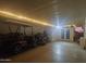 Large covered parking area with a golf cart and motorcycle parked beneath the warm string lights at 650 N Hawes Rd # 2713, Mesa, AZ 85207