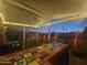 Screened-in patio with a colorful tile bar, comfortable seating, a ceiling fan, and string lights at 650 N Hawes Rd # 2713, Mesa, AZ 85207