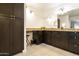 Bathroom boasts dark brown vanity with granite countertop and large mirror at 663 S Saguaro Way, Mesa, AZ 85208