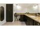 Bathroom features dark brown vanity with granite countertop and large mirror at 663 S Saguaro Way, Mesa, AZ 85208