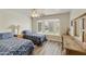 Guest bedroom with twin beds, a bay window, and built-in wooden dresser at 663 S Saguaro Way, Mesa, AZ 85208
