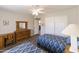 Bedroom with twin beds, wooden dresser, and ample closet space at 663 S Saguaro Way, Mesa, AZ 85208