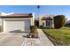 Condo exterior featuring a two-car garage and well-maintained landscaping at 663 S Saguaro Way, Mesa, AZ 85208
