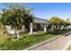 Charming home exterior with covered patio and lush landscaping at 663 S Saguaro Way, Mesa, AZ 85208