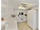 White kitchen with ample cabinetry, stainless steel appliances, and a breakfast bar at 663 S Saguaro Way, Mesa, AZ 85208