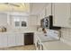 White kitchen with stainless steel appliances and ample counter space at 663 S Saguaro Way, Mesa, AZ 85208