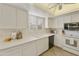 White kitchen with stainless steel appliances and ample counter space at 663 S Saguaro Way, Mesa, AZ 85208
