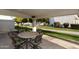Covered patio with a table and chairs, ideal for outdoor dining at 663 S Saguaro Way, Mesa, AZ 85208