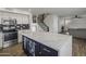 Modern kitchen with white cabinets, large island, and geometric backsplash at 6644 E Snowdon Cir, Mesa, AZ 85215