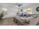 Living room with sectional sofa, hardwood floors, and ceiling fan at 6644 E Snowdon Cir, Mesa, AZ 85215