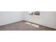 Bright bedroom featuring soft carpet, ample natural light, and a view of the home across the street at 8470 W Mantle Way, Florence, AZ 85132
