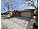 Single-story house with a well-manicured lawn, garage, and an American flag displayed at 8927 E Posada Ave, Mesa, AZ 85212