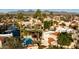 Extensive aerial view with lake, pool, red-tiled roofs, mountain backdrop, and lush desert landscaping at 10050 E Mountainview Lake Dr # 39, Scottsdale, AZ 85258