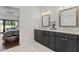 Bathroom with double vanity, marble countertops, and a view into the bedroom at 10050 E Mountainview Lake Dr # 39, Scottsdale, AZ 85258