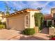 Two car garage in a neutral color with a tile roof and manicured landscaping at 10050 E Mountainview Lake Dr # 39, Scottsdale, AZ 85258