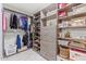 Spacious walk-in closet with custom shelving, drawers, and hanging rods for organization at 10050 E Mountainview Lake Dr # 39, Scottsdale, AZ 85258