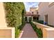 Charming walkway with lush greenery creating a private entrance to the home at 10050 E Mountainview Lake Dr # 39, Scottsdale, AZ 85258