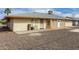 The backyard shows a spacious area with gravel landscaping and a covered patio, along with a sunroom extension at 10437 W Caron Dr, Sun City, AZ 85351