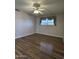 Bright bedroom featuring wood-look floors and a ceiling fan at 10437 W Caron Dr, Sun City, AZ 85351