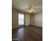 Well-lit bedroom with hardwood floors and a window at 10437 W Caron Dr, Sun City, AZ 85351