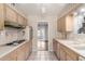 Functional kitchen with oven, cooktop, plenty of cabinet space, and doorway that leads to another room at 10437 W Caron Dr, Sun City, AZ 85351