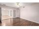 Bright room with hardwood floors and glass french doors leading to another living space at 10437 W Caron Dr, Sun City, AZ 85351