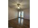 Living room with wood-look floors and French doors leading to sunroom at 10437 W Caron Dr, Sun City, AZ 85351