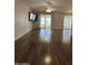 Large living room with hardwood floors and sliding doors to patio at 10437 W Caron Dr, Sun City, AZ 85351