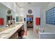 Elegant bathroom with double vanity, walk-in shower, and soaking tub at 10788 E Raintree Dr, Scottsdale, AZ 85255