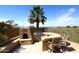 Outdoor kitchen with grill and seating area at 10788 E Raintree Dr, Scottsdale, AZ 85255