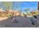 Desert landscaping highlights this backyard, complete with low-water plants and natural rock features at 11222 E Oberlin Way, Scottsdale, AZ 85262