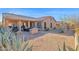 Expansive backyard with desert landscape, covered patio, outdoor kitchen and dining area at 11222 E Oberlin Way, Scottsdale, AZ 85262