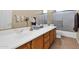 Bathroom with double sink vanity and sliding glass shower door at 11222 E Oberlin Way, Scottsdale, AZ 85262