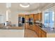 Modern kitchen featuring granite countertops, stainless steel appliances, and wood cabinets at 11222 E Oberlin Way, Scottsdale, AZ 85262