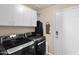 Well-lit laundry room features modern appliances, upper cabinets, and access door at 11222 E Oberlin Way, Scottsdale, AZ 85262