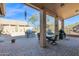 Covered outdoor patio with a built-in BBQ, a dining table, and a low brick fence at 11222 E Oberlin Way, Scottsdale, AZ 85262