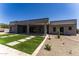 Beautiful backyard featuring a covered patio, artificial grass, and desert landscaping at 12560 E Cochise Dr, Scottsdale, AZ 85259