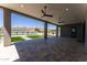 Spacious covered patio with ceiling fans and a view of the pool and mountains at 12560 E Cochise Dr, Scottsdale, AZ 85259