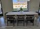 Bright dining room with a large window view and a modern chandelier at 12560 E Cochise Dr, Scottsdale, AZ 85259