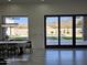 Bright dining room with modern chandelier, large windows to the backyard with a pool at 12560 E Cochise Dr, Scottsdale, AZ 85259