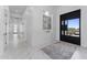 Welcoming entryway boasts a black door with an artistic painting and marble floors at 12560 E Cochise Dr, Scottsdale, AZ 85259