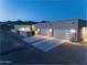 A modern home with three garage spaces at dusk at 12560 E Cochise Dr, Scottsdale, AZ 85259