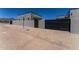 Modern home with a black gate, desert landscaping, and block wall at 12560 E Cochise Dr, Scottsdale, AZ 85259